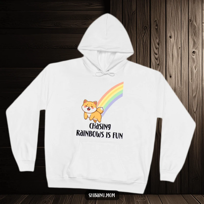 Funny Shiba Inu hoodie showing a dog sliding down a vibrant rainbow, radiating happiness and giggles.
