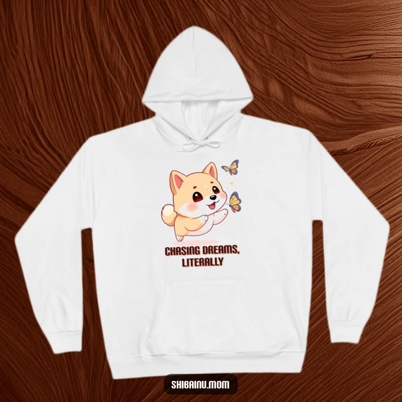 Funny Shiba Inu hoodie with sparkling eyes, enthusiastically chasing a butterfly, embodying a spirit of carefree joy and adventure.