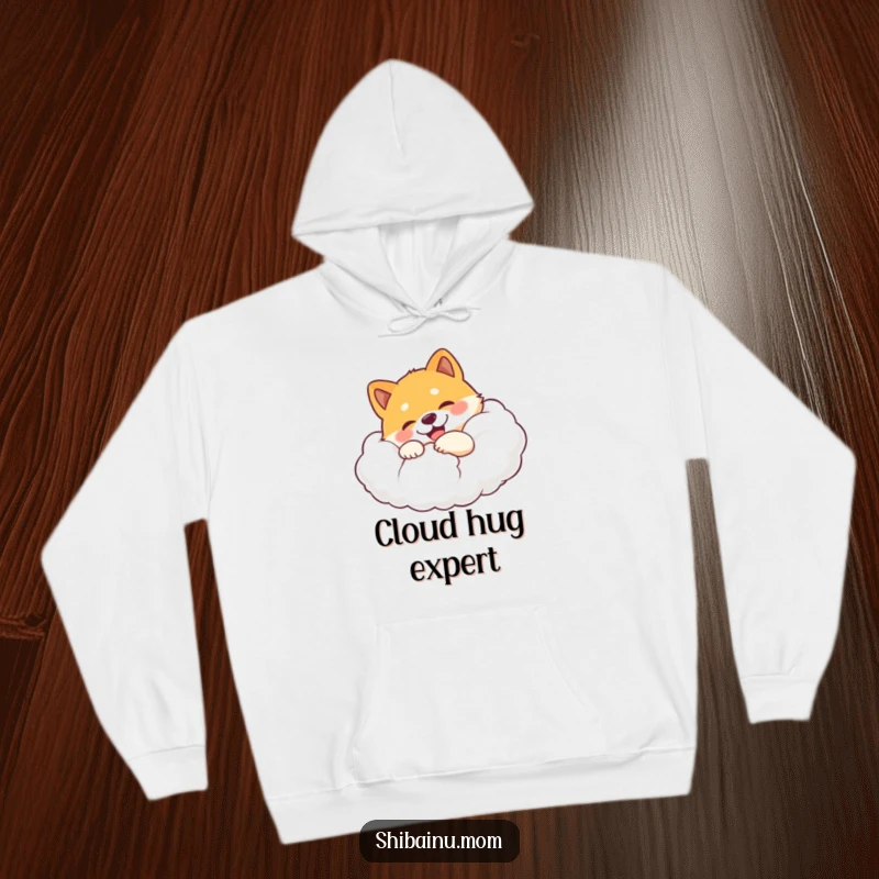 Funny Shiba Inu hoodie featuring a happy dog hugging a huge, soft cloud with an expression of absolute delight.