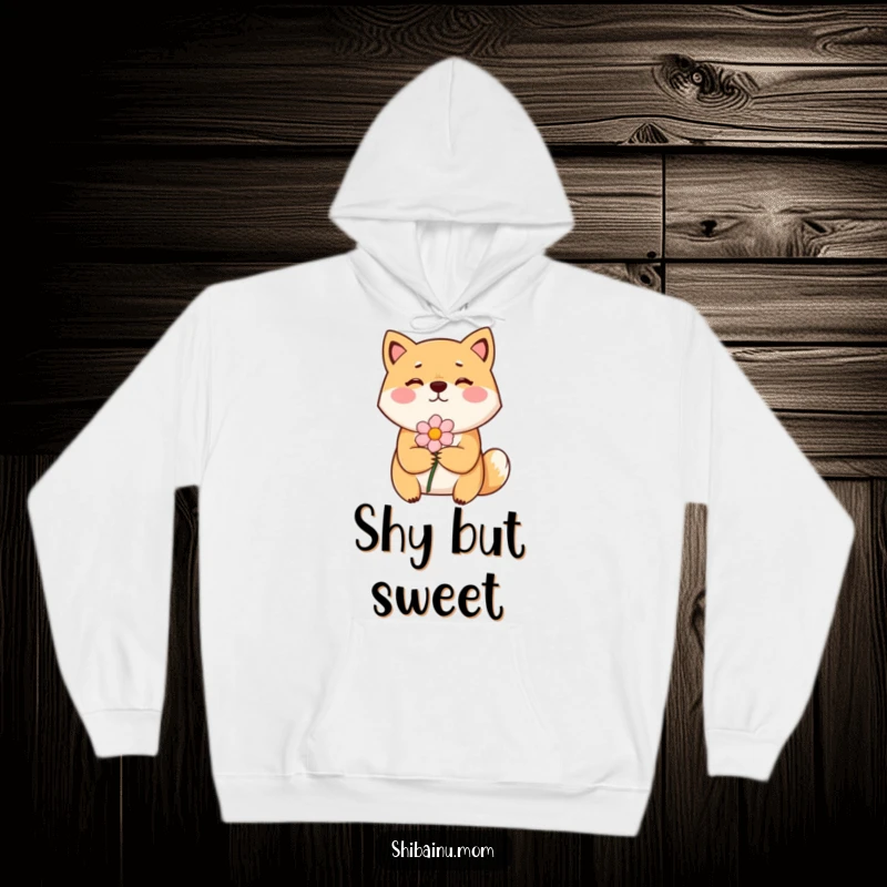 Funny Shiba Inu hoodie showing a bashful dog with flushed cheeks, holding out a flower with shy tenderness.